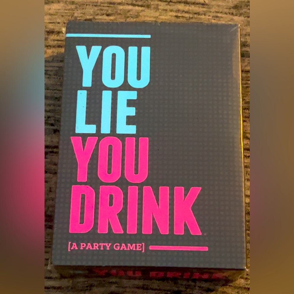 YOU LIE YOU DRINK. brand new still has plastic film protection wrap on it!